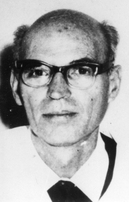Portrait of Professor D. Paskov (1914 to 1986), a man in a suit and tie with glasses, in black and white